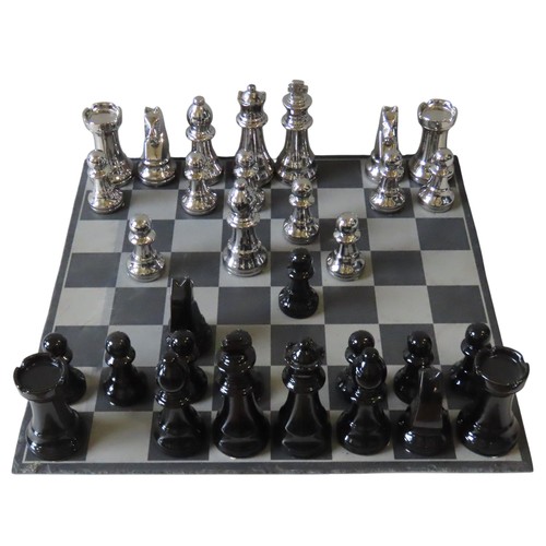 428 - A CONTEMPORARY OVERSIZED CERAMIC CHESS SET, with silver and black coloured pieces, on a slate games ... 