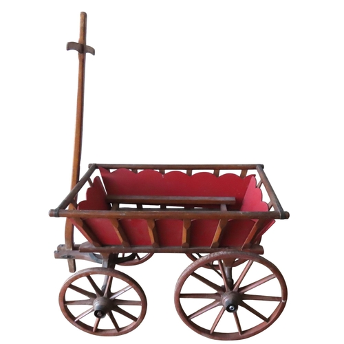 459 - A RUSTIC PULL ALONG HAND CART, the tapering rectangular carriage with painted insert panels, with de... 