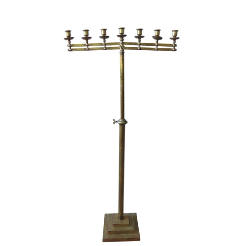 94 - AN ECCLESIASTIC BRASS CANDELABRUM, comprised of seven sconces sat atop pivoting twin branches, on an... 