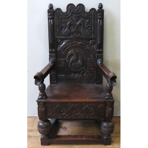 15 - A CARVED OAK WAINSCOT CHAIR, 19TH CENTURY, serpentine top rail over a heavily carved back panel deco... 