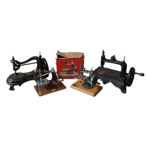 432 - TWO CAST-IRON HAND CRANK SEWING MACHINES, LATE 19TH CENTURY, together with a vintage 'Grain' toy sew... 