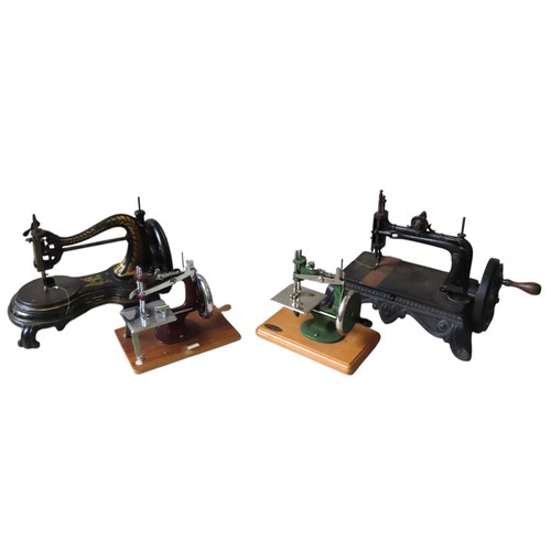 432 - TWO CAST-IRON HAND CRANK SEWING MACHINES, LATE 19TH CENTURY, together with a vintage 'Grain' toy sew... 