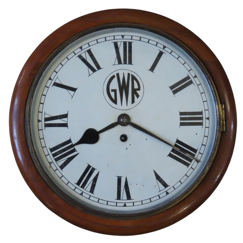 A VINTAGE CIRCULAR CASED GWR WALL CLOCK, with a single fusee movement, the 30 cm white painted dial inscribed GWR, with Roman numerals, the side of the case bearing a label marked 'GWR, 3847'