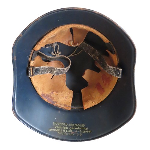 144 - A GERMAN WWII LUFTSCHUTZ HELMET AND A BRITISH AIR WARDEN HELMET, the German helmet with winged swast... 