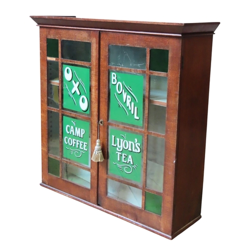 36 - TWO VINTAGE OAK DISPLAY CABINETS, one with green glass corner panels, painted with adverts for Oxo, ... 