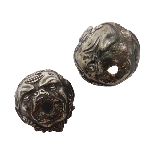 202 - A PAIR OF 18TH CENTURY WHITE METAL PISTOL BUTTS in the form of grotesque masks, one bearing two stam... 