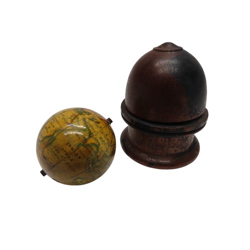 315 - AN EARLY 19TH CENTURY MINIATURE GLOBE contained in a domed-top turned wooden case, the globe support... 