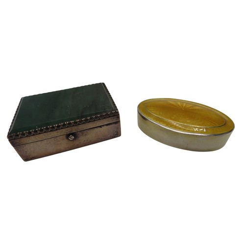 307 - A WHITE METAL 'PILL' BOX WITH GREEN AGATE INSET LID and an oval circular silver box with yellow enam... 