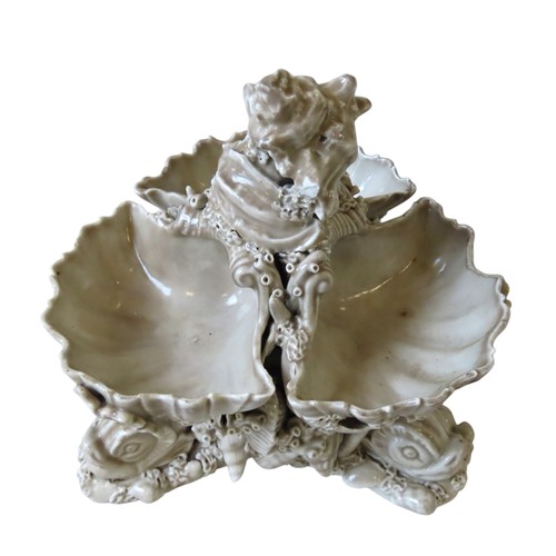 181 - PORCELAIN CONTINENTAL SWEET MEAT DISH in the form of three clam shells supported on stylised dolphin... 