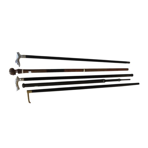 253 - A MIXED GROUP OF FOUR WALKING CANES, including a carved hardwood bone inset cane, a compass inset ca... 