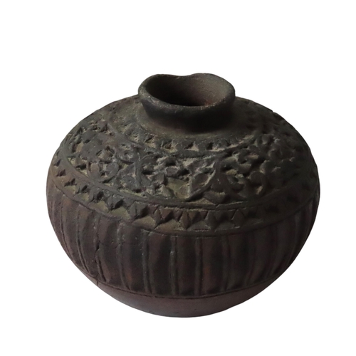 470 - AN INDIAN INCISED POTTERY JAR, compressed globular form with incised bands of scroll foliate decorat... 