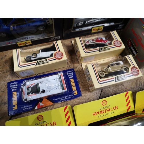 158 - A COLLECTION OF OVER 20 BOXED MODEL CARSIncluding 1:36 Maisto models for the Shell Sportscar colleci... 