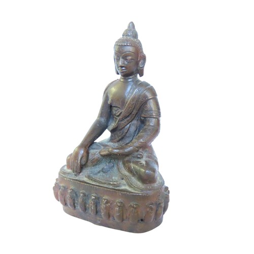 507 - A CAST BRONZE FIGURE OF BUDDHA, modelled in flowing robes, seated cross legged on a lotus form base1... 