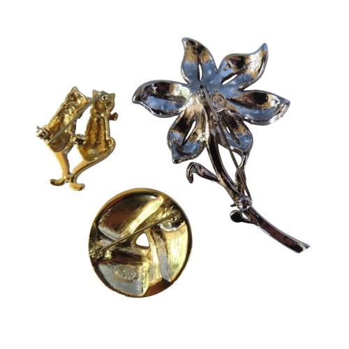 512 - TWO BUTLER & WILSON PASTE SET COSTUME BROOCHES, one modelled as a flower, the other as two seate... 