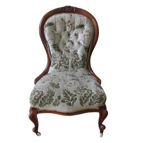 87 - A VICTORIAN MAHOGANY NURSING CHAIR, spoon back form, covered in a floral brocade fabric, raised on c... 