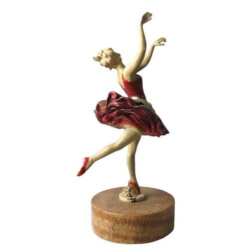 79 - A VINTAGE COLD PAINTED FIGURINE OF BALLET DANCER, raised on a circular marble plinth28 cm highProven... 