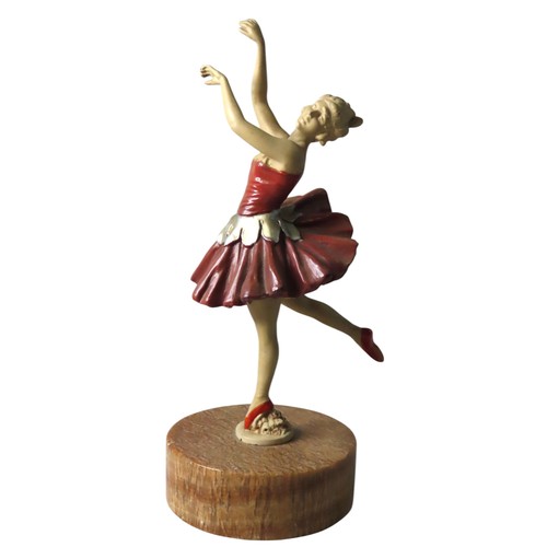 79 - A VINTAGE COLD PAINTED FIGURINE OF BALLET DANCER, raised on a circular marble plinth28 cm highProven... 