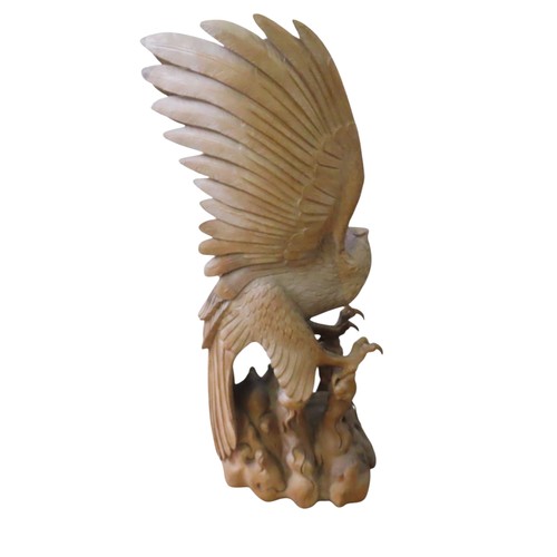 24 - A VERY LARGE IMPRESSIVE CARVED PINE EAGLE, modelled taking flight from a rocky outcrop, with wings s... 