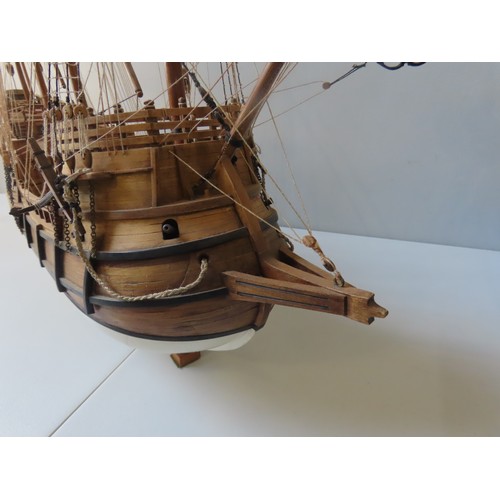 70 - A WOODEN MODEL OF A SPANISH 16TH CENTURY GALLEON, with four fully rigged masts and twenty two guns, ... 