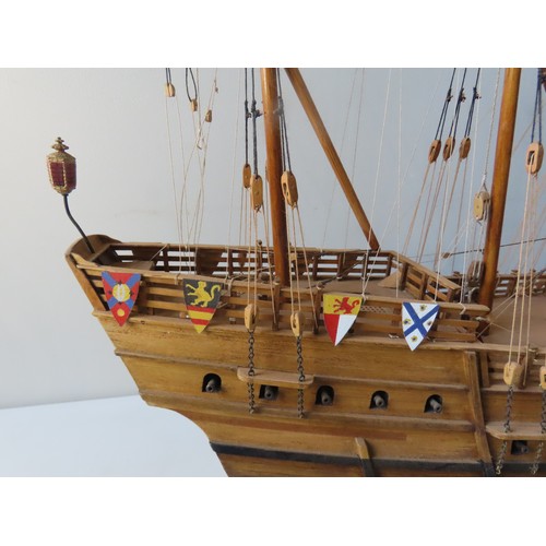 70 - A WOODEN MODEL OF A SPANISH 16TH CENTURY GALLEON, with four fully rigged masts and twenty two guns, ... 