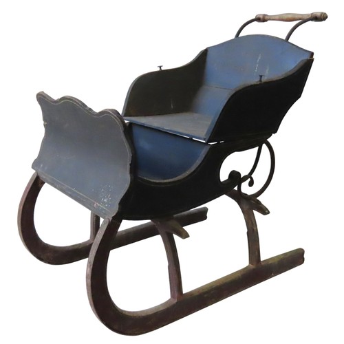 72 - A VINTAGE PINE AND CAST-IRON CHILDREN'S SLEIGH, with a turned wooden handle on scrolling iron uprigh... 