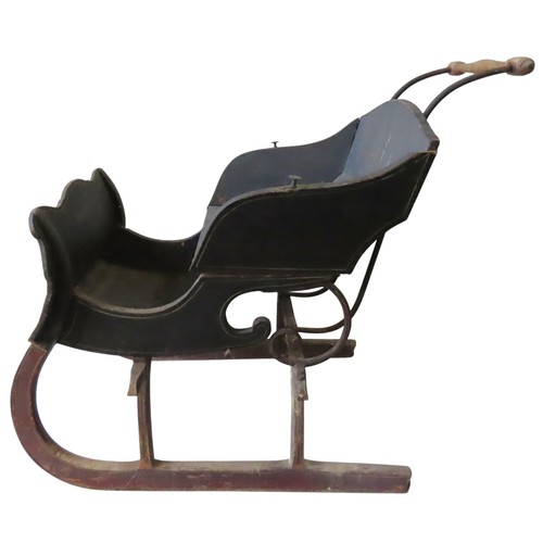 72 - A VINTAGE PINE AND CAST-IRON CHILDREN'S SLEIGH, with a turned wooden handle on scrolling iron uprigh... 