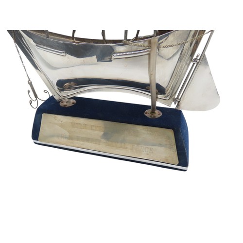 A STERLING SILVER MODEL DHOW, with Sharjah House mark to the sail, and ...