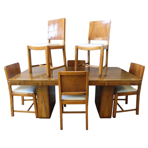 97 - AN ART DECO WALNUT DINING TABLE AND SIX CHAIRS, CIRCA 1935, the rectangular top with graduated edge ... 