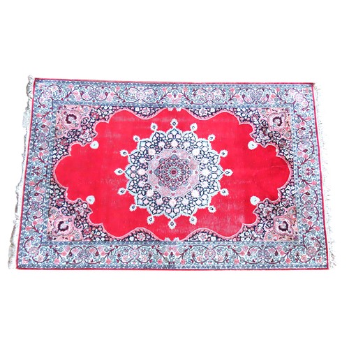 611 - A PERSIAN DEEP BORDER RUG, WITH CENTRAL MANDALA DECORATION ON A CHERRY RED GROUND182 x 122 cm