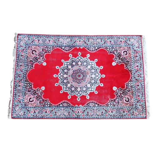 611 - A PERSIAN DEEP BORDER RUG, WITH CENTRAL MANDALA DECORATION ON A CHERRY RED GROUND182 x 122 cm