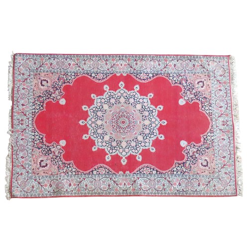 611 - A PERSIAN DEEP BORDER RUG, WITH CENTRAL MANDALA DECORATION ON A CHERRY RED GROUND182 x 122 cm