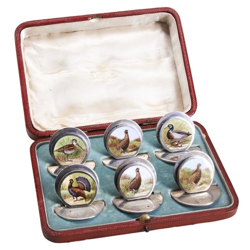 133 - A SET OF SIX SAMPSON MORDAN SILVER ENAMELLED GAME BIRD MENU HOLDERS, featuring various birds includi... 