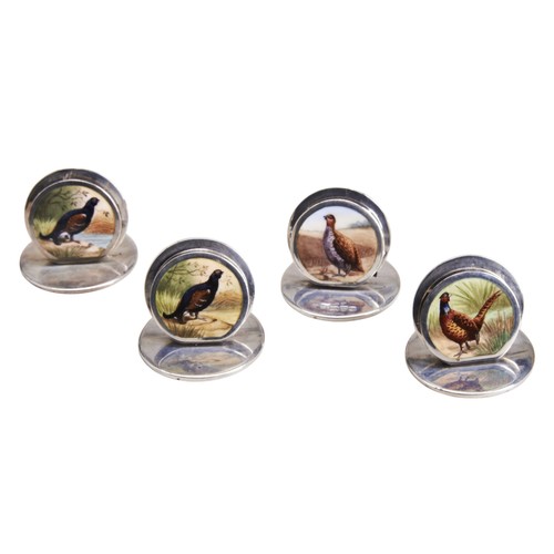 132 - A SET OF FOUR SAMPSON MORDAN & CO GAME BIRD SILVER MENU HOLDERS, with circular enamelled plaques... 