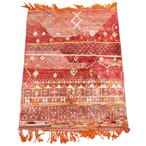 142 - WOOLLEN RUG Red ground, unusual varied pattern, orange fringing 215cm x 148cm PROVENANCE: From The H... 