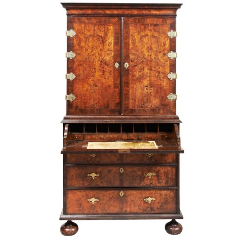 143 - A FINE WILLIAM AND MARY WALNUT AND FEATHER BANDED SECRETAIRE CABINET ON STAND CIRCA 1700 the moulded... 