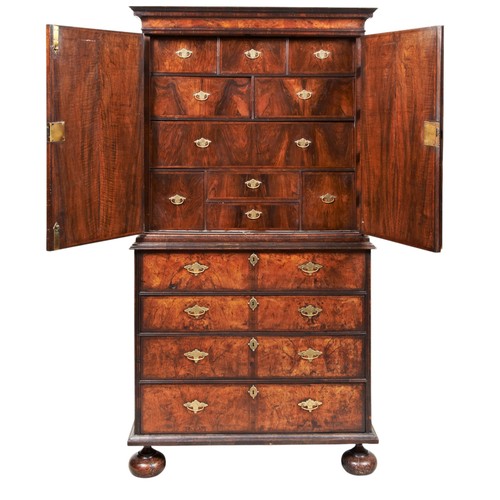 143 - A FINE WILLIAM AND MARY WALNUT AND FEATHER BANDED SECRETAIRE CABINET ON STAND CIRCA 1700 the moulded... 