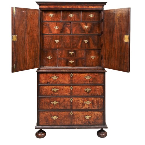 143 - A FINE WILLIAM AND MARY WALNUT AND FEATHER BANDED SECRETAIRE CABINET ON STAND CIRCA 1700 the moulded... 