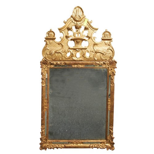 67 - AN 18th CENTURY STYLE MIRROR, the gilt gesso frame with mirrored side strips and aged plate, surmoun... 