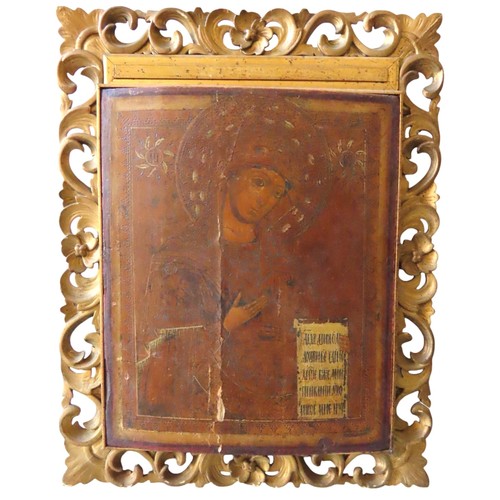 536 - A 19th CENTURY GREEK ICON of the Madonna on a curved board (one back strut missing) and mounted in a... 