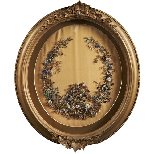 535 - A PAIR OF 19TH CENTURY OVAL FRAMED FLORAL PANELSCIRCA 1870, both with arrangements of dried flowers ... 