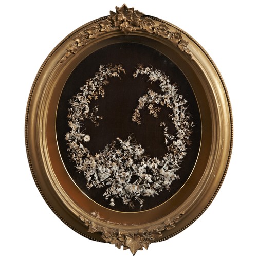 535 - A PAIR OF 19TH CENTURY OVAL FRAMED FLORAL PANELSCIRCA 1870, both with arrangements of dried flowers ... 