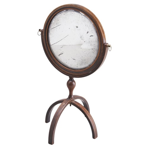 429 - A GEORGE III MAHOGANY TRAVEL MIRRORCIRCA 1820the tilting double sided circular plate on a a baluster... 