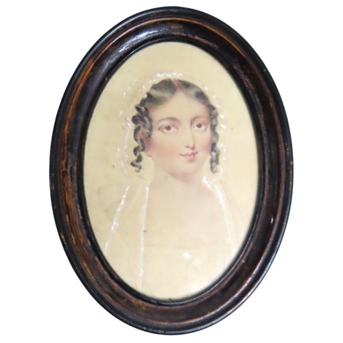 553 - A GEORGIAN SILHOUETTE OF A LADY in a walnut frame with old label verso 'Mrs Scott April 1831' and a ... 