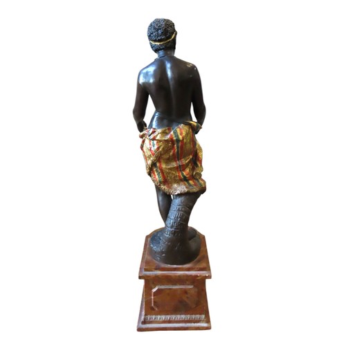 507 - A 19TH CENTURY TERRACOTTA BLACKAMOOR, modelled standing, holding a fruit basket, raised on a plinth ... 