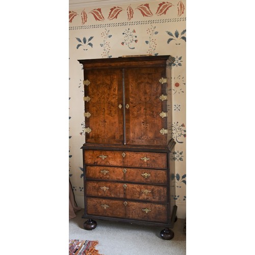 143 - A FINE WILLIAM AND MARY WALNUT AND FEATHER BANDED SECRETAIRE CABINET ON STAND CIRCA 1700 the moulded... 