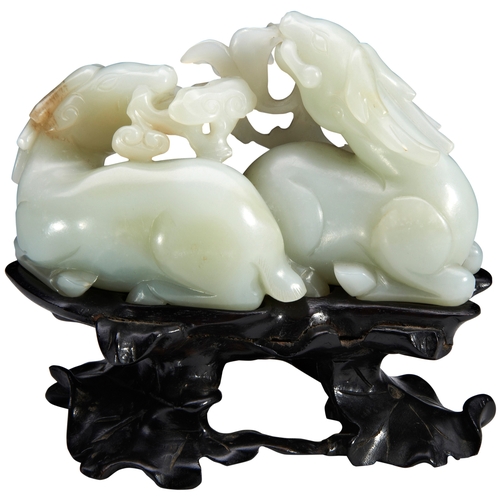 36 - A FINE CARVED PALE-GREEN JADE GROUP OF TWO STAGS QIANLONG PERIOD (1736-1795)青白玉鹿衔玉兰摆件 乾隆 1736-1795mo... 