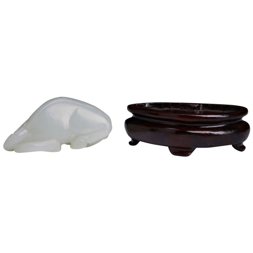 109 - A WHITE JADE CARVING OF A RECUMBENT HORSE,CIRCA 1800白玉马 清 十九世纪初with its head turned biting its hoof,... 