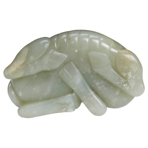128 - A PALE CELADON JADE BUFFALOQING DYNASTY, 18TH CENTURY青白玉牛 清 十八世纪crisply carved with its head turned ... 
