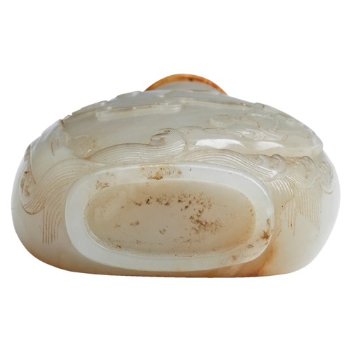 118 - A FINE CARVED PALE-CELADON AND RUSSET JADE SNUFF BOTTLEPOSSIBLY MASTER OF THE ROCKS SCHOOL, QING DYN... 
