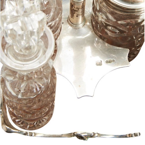 92 - A VICTORIAN SILVER CRUET STAND, LONDON 1865A six bottle cruet stand with engraved decoration on four... 